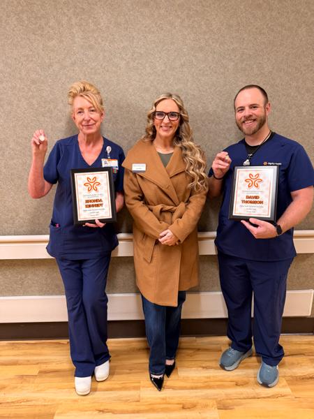 Jen from the Husband & Wife Law Team, standing next to Rhonda and David with their Guardian Angel Awards