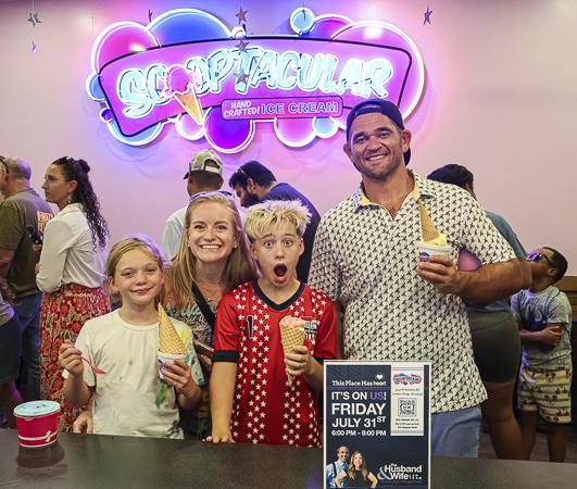 A family of four enjoys ice cream together at the SCOOPTACULAR HEART Event, making sweet memories while celebrating community and connection.